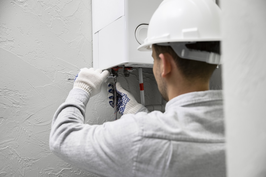 worker-repairing-water-heater Urgent plumbing repair